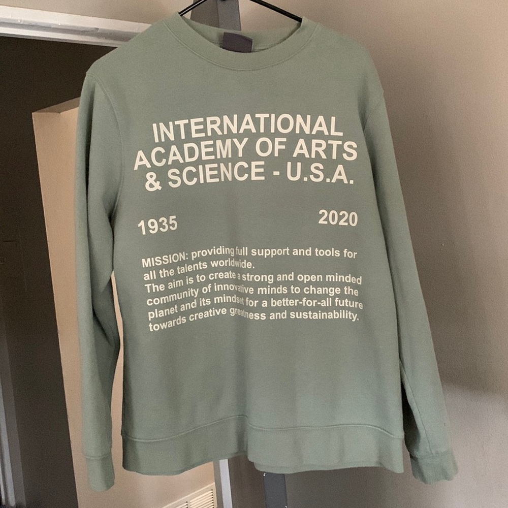 Green with beige writing pullover